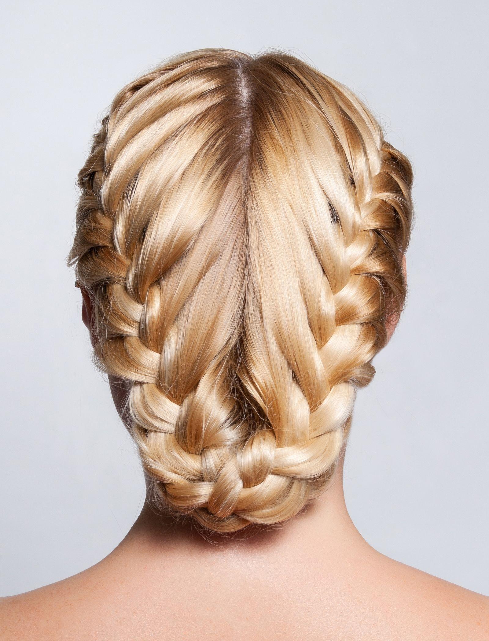 Close-up studio detail of an intricate double braided hairstyle in blonde hair