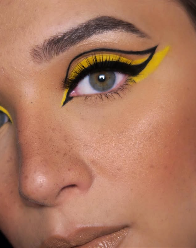 Bold graphic yellow and black winged eyeliner, close-up editorial detail